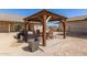 Outdoor patio area with a wooden pergola, seating, a grill, and planters at 36249 N 7Th St, Phoenix, AZ 85086