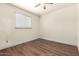 Bright room with light walls, wood-look floors, a window and a ceiling fan with a light fixture at 4003 S Mill Ave, Tempe, AZ 85282
