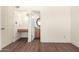 Bright room showcasing light walls, wood-look floors, an attached vanity area and access to a full bathroom at 4003 S Mill Ave, Tempe, AZ 85282