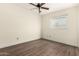 Bright room with light walls, wood-look floors, a window and a ceiling fan with a light fixture at 4003 S Mill Ave, Tempe, AZ 85282