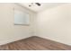 Bedroom features light colored walls, wood-look floors, and a window at 4003 S Mill Ave, Tempe, AZ 85282