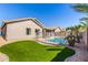 Spacious backyard with lush artificial turf, fenced pool, and desert landscaping at 4245 E Maya Way, Cave Creek, AZ 85331