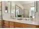 Bathroom featuring a dual sink vanity with wood cabinets and a large mirror at 4245 E Maya Way, Cave Creek, AZ 85331
