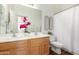 Bathroom with dual sinks, wood cabinets, and decorative accents at 4245 E Maya Way, Cave Creek, AZ 85331