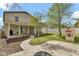 A beautiful backyard with green grass, a stone patio and walkway, and a covered patio area at 4304 E Whitehall Dr, San Tan Valley, AZ 85140