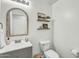 Charming half bath features a decorative mirror and stylish shelving for added flair at 4304 E Whitehall Dr, San Tan Valley, AZ 85140