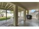 Covered patio with stone flooring, grill, and view of the grassy backyard and playhouse at 4304 E Whitehall Dr, San Tan Valley, AZ 85140