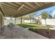 The covered patio features stone flooring, outdoor seating and a view of the landscaped backyard at 4304 E Whitehall Dr, San Tan Valley, AZ 85140