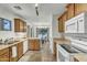 Efficient kitchen featuring wood cabinetry, white appliances, and a view into the adjacent dining area at 4304 E Whitehall Dr, San Tan Valley, AZ 85140