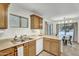 Functional kitchen space with wood cabinets, white appliances, and a convenient breakfast bar overlooking the dining area at 4304 E Whitehall Dr, San Tan Valley, AZ 85140