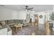 Bright living room with a comfortable sectional couch, round coffee table, and seamless flow to the kitchen at 4304 E Whitehall Dr, San Tan Valley, AZ 85140