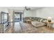 Comfortable living room with a large sectional couch, sliding glass doors, and neutral tile flooring at 4304 E Whitehall Dr, San Tan Valley, AZ 85140