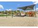Community playground with swings, climbing structures, and sun shades offering a fun recreation area for residents at 4304 E Whitehall Dr, San Tan Valley, AZ 85140