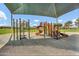 Bright and colorful community playground with multiple slides and climbing structures under a shaded canopy at 4304 E Whitehall Dr, San Tan Valley, AZ 85140