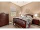 Bedroom with a bed, dressers, bedside tables, and a window for natural lighting and wall decor at 4876 N 206Th Ln, Buckeye, AZ 85396