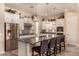 Modern kitchen featuring a center island with bar seating and stainless steel appliances at 4876 N 206Th Ln, Buckeye, AZ 85396