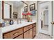 Bathroom with white countertops, wooden cabinets and decorative mirror at 5141 E Elena Ave, Mesa, AZ 85206