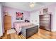 Bedroom featuring wood floors, white trim and light purple walls at 5141 E Elena Ave, Mesa, AZ 85206
