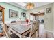 A charming dining room with a wooden table, skylight, green walls, and tile flooring at 5141 E Elena Ave, Mesa, AZ 85206