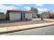 A beautiful brick home featuring desert landscaping with rocks and plants along the side of the house at 5141 E Elena Ave, Mesa, AZ 85206
