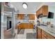 Well-lit kitchen featuring wooden cabinets, stainless steel appliances, and light countertops at 5141 E Elena Ave, Mesa, AZ 85206