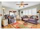 Comfortable living room featuring hardwood floors, a ceiling fan, and a cozy seating area with a side table at 5141 E Elena Ave, Mesa, AZ 85206