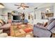 Relaxing living room with hardwood floors, TV, ceiling fan, and an open layout perfect for entertaining guests at 5141 E Elena Ave, Mesa, AZ 85206