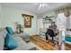 A cozy living room includes a comfortable grey couch, a crafting station, and plenty of natural light at 5141 E Elena Ave, Mesa, AZ 85206