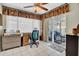 Well-lit office space with tile floors, a desk, natural lighting and a sliding glass door to the patio at 5141 E Elena Ave, Mesa, AZ 85206