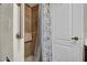 Walk-in shower features tile surround and shower curtain for privacy at 5141 E Elena Ave, Mesa, AZ 85206