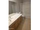Neutral bathroom with light wood vanity, tile floors, and a shower-tub combination at 5501 S Dove Crk Crk, Buckeye, AZ 85326