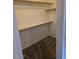 This is a well-organized closet with built-in shelving and neutral carpeting at 5501 S Dove Crk Crk, Buckeye, AZ 85326