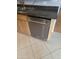 Stainless steel KitchenAid dishwasher in a modern kitchen with tile floors and wood cabinetry at 5501 S Dove Crk Crk, Buckeye, AZ 85326