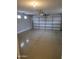Attached garage with neutral flooring, an automatic garage door, and windows at 5501 S Dove Crk Crk, Buckeye, AZ 85326