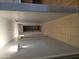 Tiled hallway showcasing neutral walls, inset lighting, and multiple doors at 5501 S Dove Crk Crk, Buckeye, AZ 85326