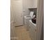 Utility/laundry room with washer, dryer, and storage shelf at 5501 S Dove Crk Crk, Buckeye, AZ 85326