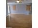 Spacious living area featuring hardwood floors, neutral walls, and natural light from the windows at 5501 S Dove Crk Crk, Buckeye, AZ 85326