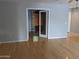 Bright living room with hardwood floors leading to a room with wooden blinds through glass french doors at 5501 S Dove Crk Crk, Buckeye, AZ 85326