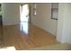 Bright living room featuring beautiful hardwood floors and natural light from multiple windows at 5501 S Dove Crk Crk, Buckeye, AZ 85326