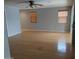 Large living room featuring hardwood floors, a ceiling fan, and wood blinds at 5501 S Dove Crk Crk, Buckeye, AZ 85326