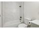 This updated bathroom features a shower over tub with white marble tiled walls and modern fixtures at 6173 N Granite Reef Rd, Scottsdale, AZ 85250