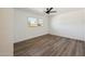 Bedroom with wood-look floors, bright window, and a ceiling fan at 6173 N Granite Reef Rd, Scottsdale, AZ 85250