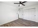 A clean bedroom design with hardwood floors, ceiling fan and closet for optimal space at 6173 N Granite Reef Rd, Scottsdale, AZ 85250