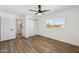 Bright bedroom with wood-look floors, a ceiling fan, and a window with neighborhood views at 6173 N Granite Reef Rd, Scottsdale, AZ 85250