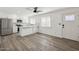 Kitchen and dining area featuring stainless steel appliances, white cabinets, and modern light fixtures at 6173 N Granite Reef Rd, Scottsdale, AZ 85250