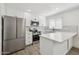 Modern kitchen with stainless steel appliances, white cabinets and countertops, and decorative backsplash at 6173 N Granite Reef Rd, Scottsdale, AZ 85250