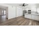 Spacious living area with wood-look floors and modern fixtures adjacent to a kitchen and dining area at 6173 N Granite Reef Rd, Scottsdale, AZ 85250