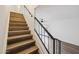 Staircase with wood steps and black metal railing connects two levels at 6173 N Granite Reef Rd, Scottsdale, AZ 85250