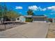 Well-maintained gray home featuring a wide driveway and solar panels on roof at 646 W Yale Dr, Tempe, AZ 85283