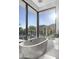 Bright bathroom featuring a modern tub with backyard views at 6601 E San Miguel Ave, Paradise Valley, AZ 85253